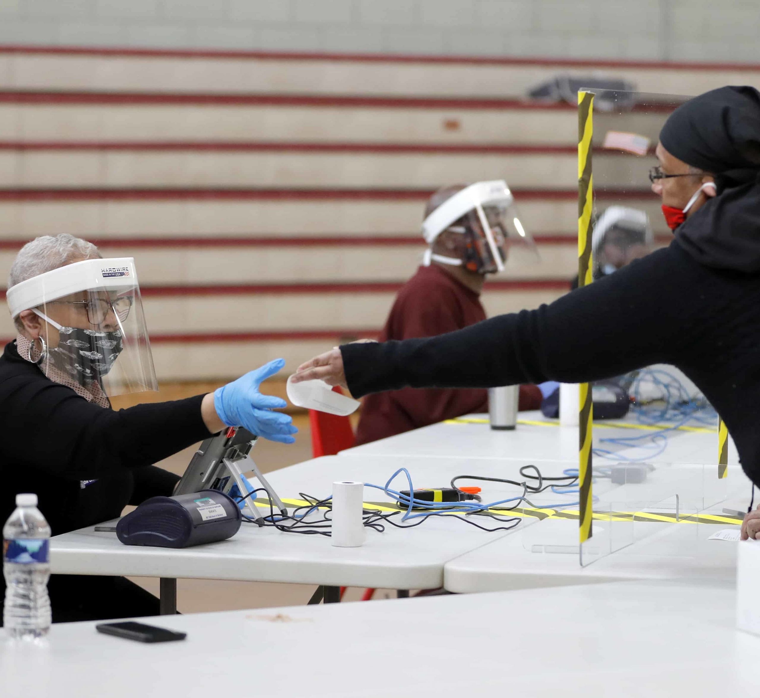 Poll worker helps voter