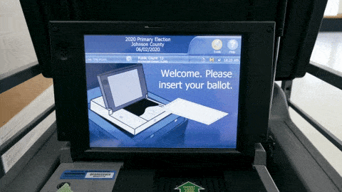 A ballot scanning machine provides instructions for voters to submit their ballots.
