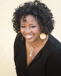 Yanick Rice Lamb, wearing a black top, poses for a photo. 