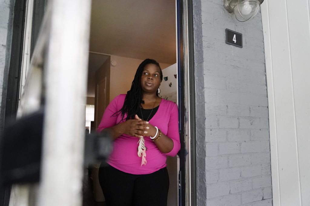 Dylyn Price, 38, of Athens, Ga., looks out a doorway from her kitchen at her rented townhome in Athens, Ga.