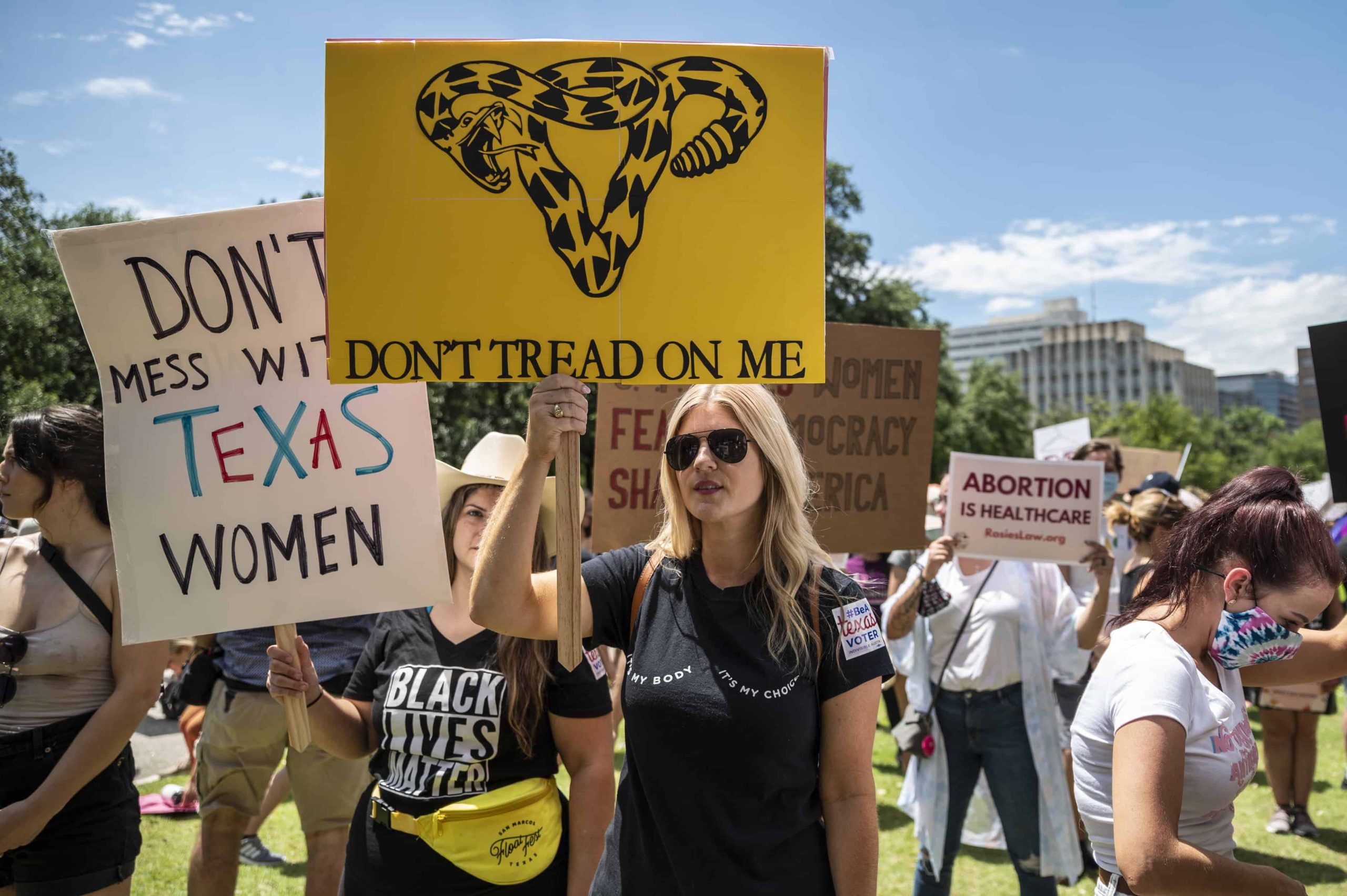 Protester holds up a "Don't tread on me" and "Don't mess with Texas women" signs at a protest outside the Texas state capitol on May 29, 2021 in Austin, Texas.