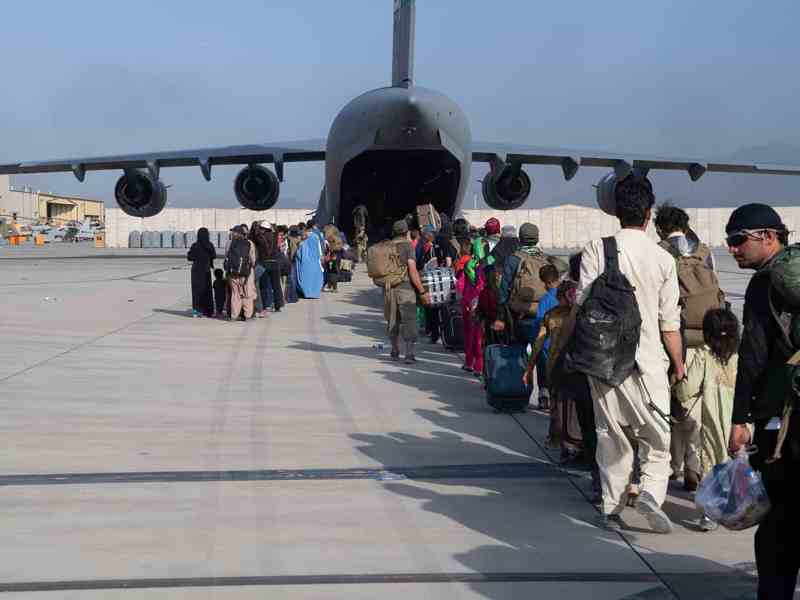 U.S. forces load passengers aboard a plane in support of the Afghanistan evacuation at Hamid Karzai International Airport.