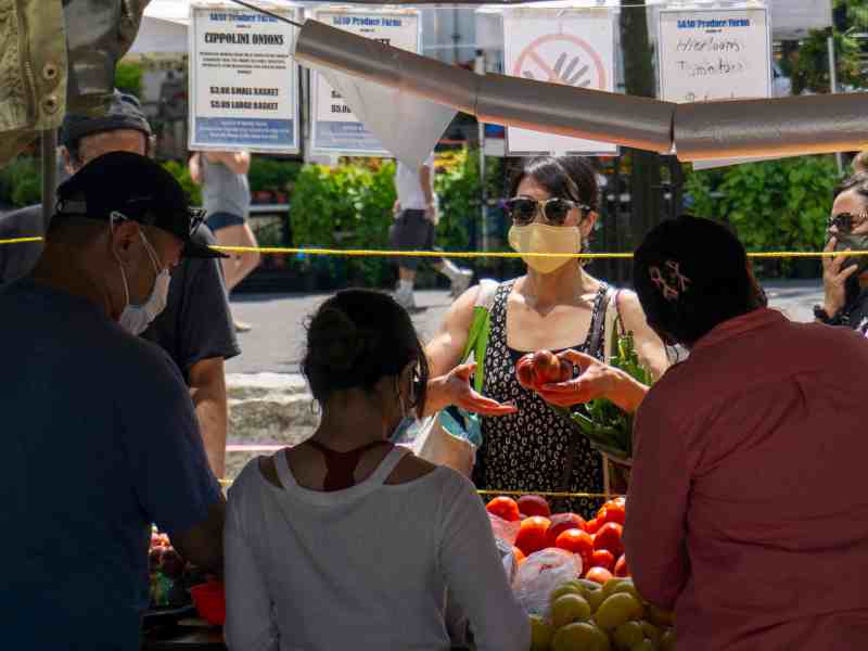 Vendors sell vegetables at a farmer's market in New York City.