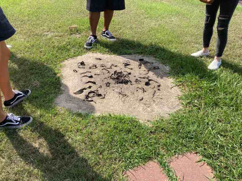 Tourists stand around chains and shackles placed in concrete. Mississippi did not expand Medicaid.