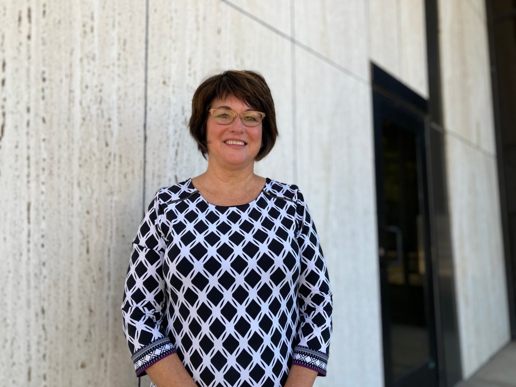 Stacey Bentley stands outside of the Community Bank & Trust.