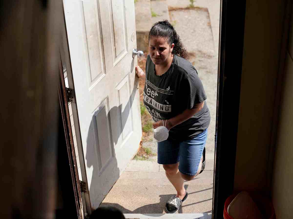 Roxanne Schaefe enters an outside door to her apartment building.