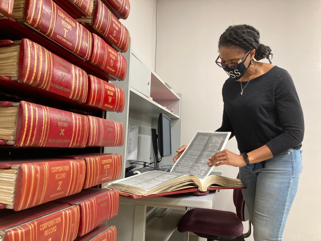 ReShonda Young looks at the restrictive covenant placed on homes in her neighborhood.