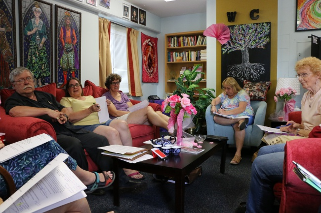 Members of the Kentucky Religious Coalition for Reproductive Choice sit on a sofa and on chairs during a meeting.