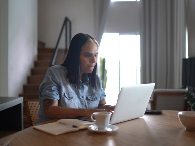 Transgender woman using laptop working from home