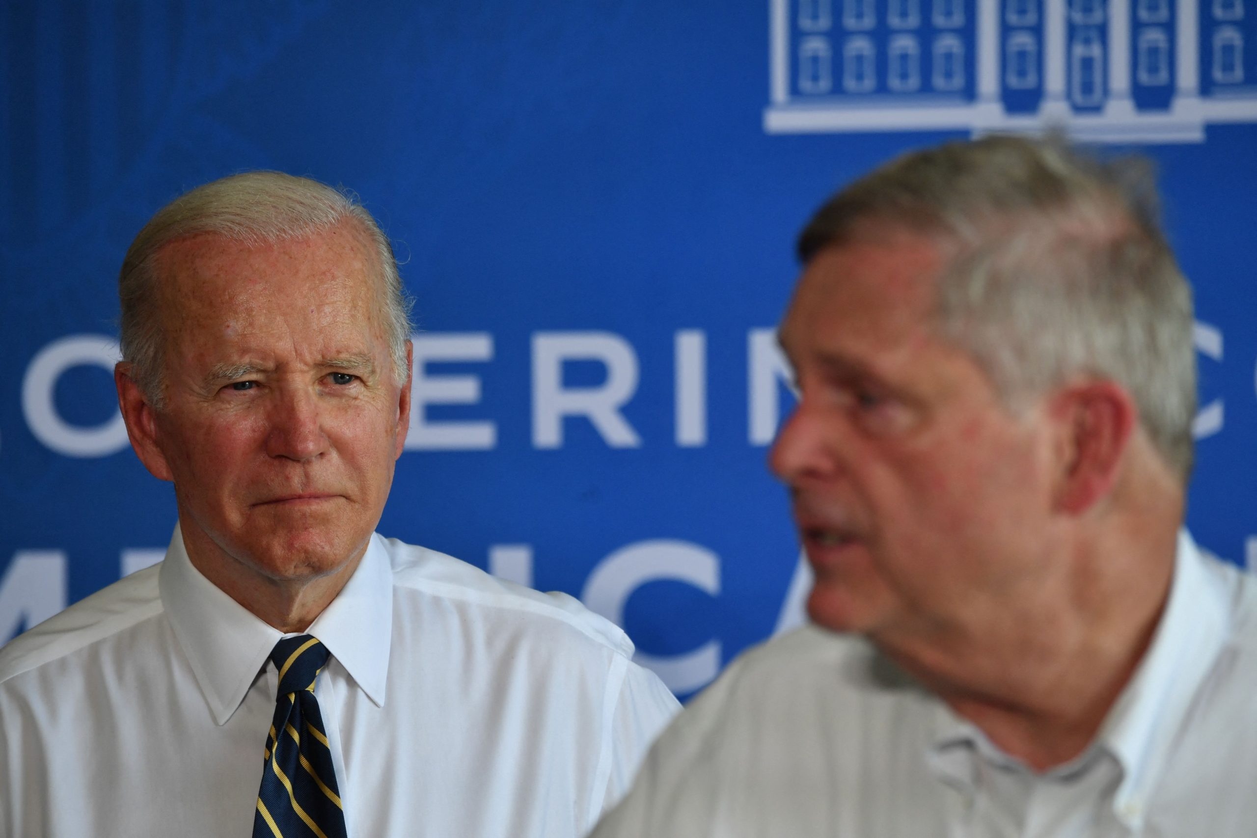 President Biden listens in the background as Tom Vilsack speaks.