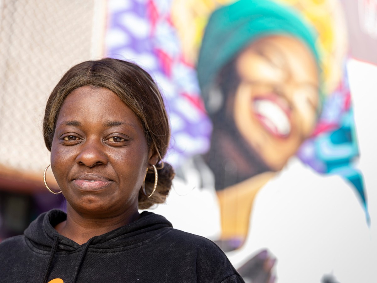 Towanda Chew looks into the camera with a determined expression and a smile.