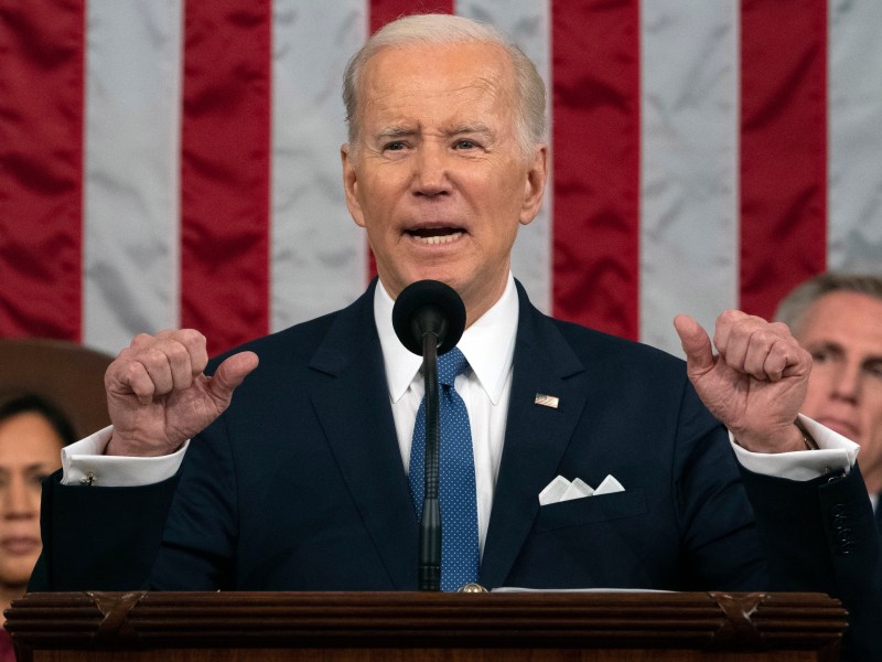 President Joe Biden raises his hands emphatically as he delivers the State of the Union address as Vice President Kamala Harris, behind him on the left, and House Speaker Kevin McCarthy, behind him on the right, listen.