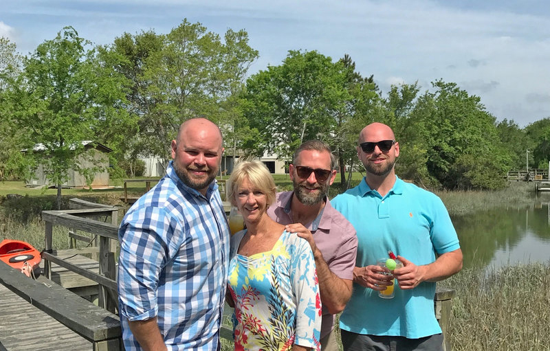 Drew Wynne (right), and his mother Cindy, with brothers, Brian and Clayton Wynne pose for a family picture on a small dock.