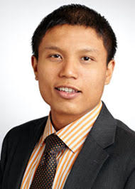 Headshot of Michael Santos, who is wearing a jacket and tie