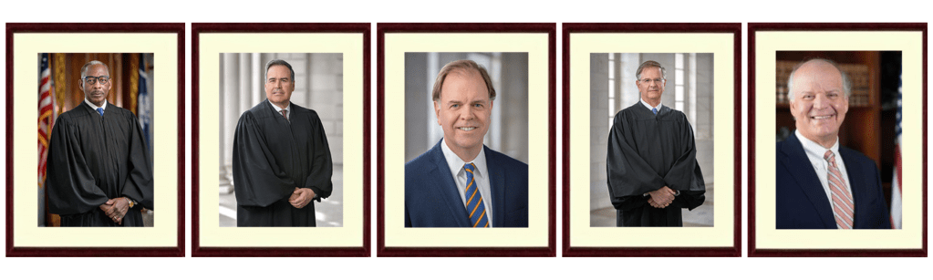 The justices are shown in identically framed photos. Three men are wearing black robes, and the other two are wearing dark blazers.