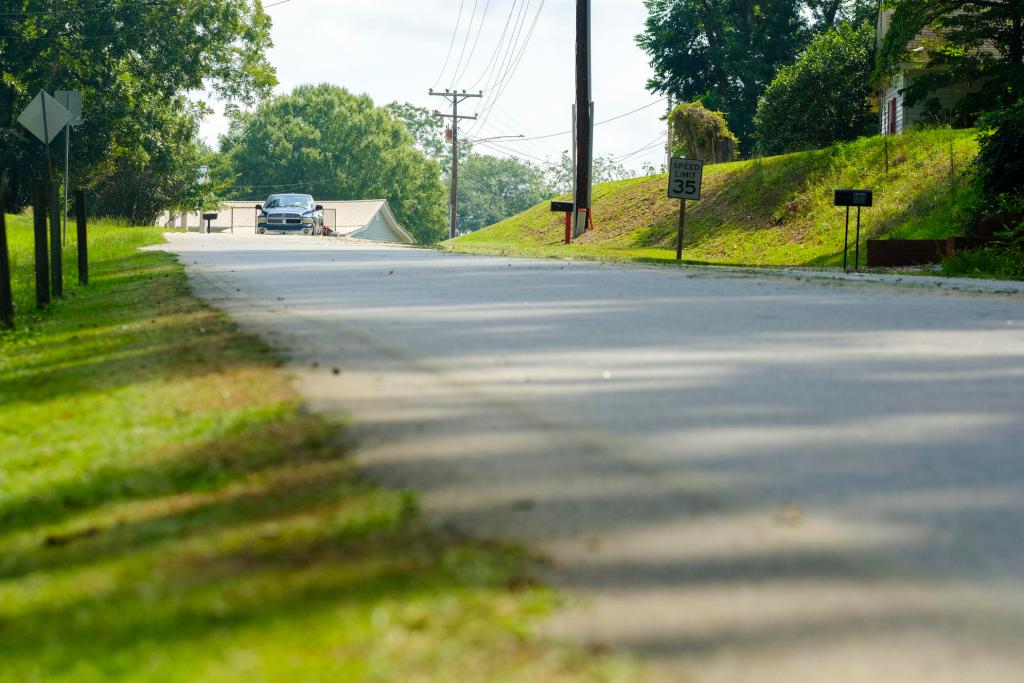 The stretch of Deepstep Road in Washington County where Eurie Martin fatally encountered Washington County Sheriff's deputies in 2017. A pickup approaches. Green grass on trees on both sides of the road.