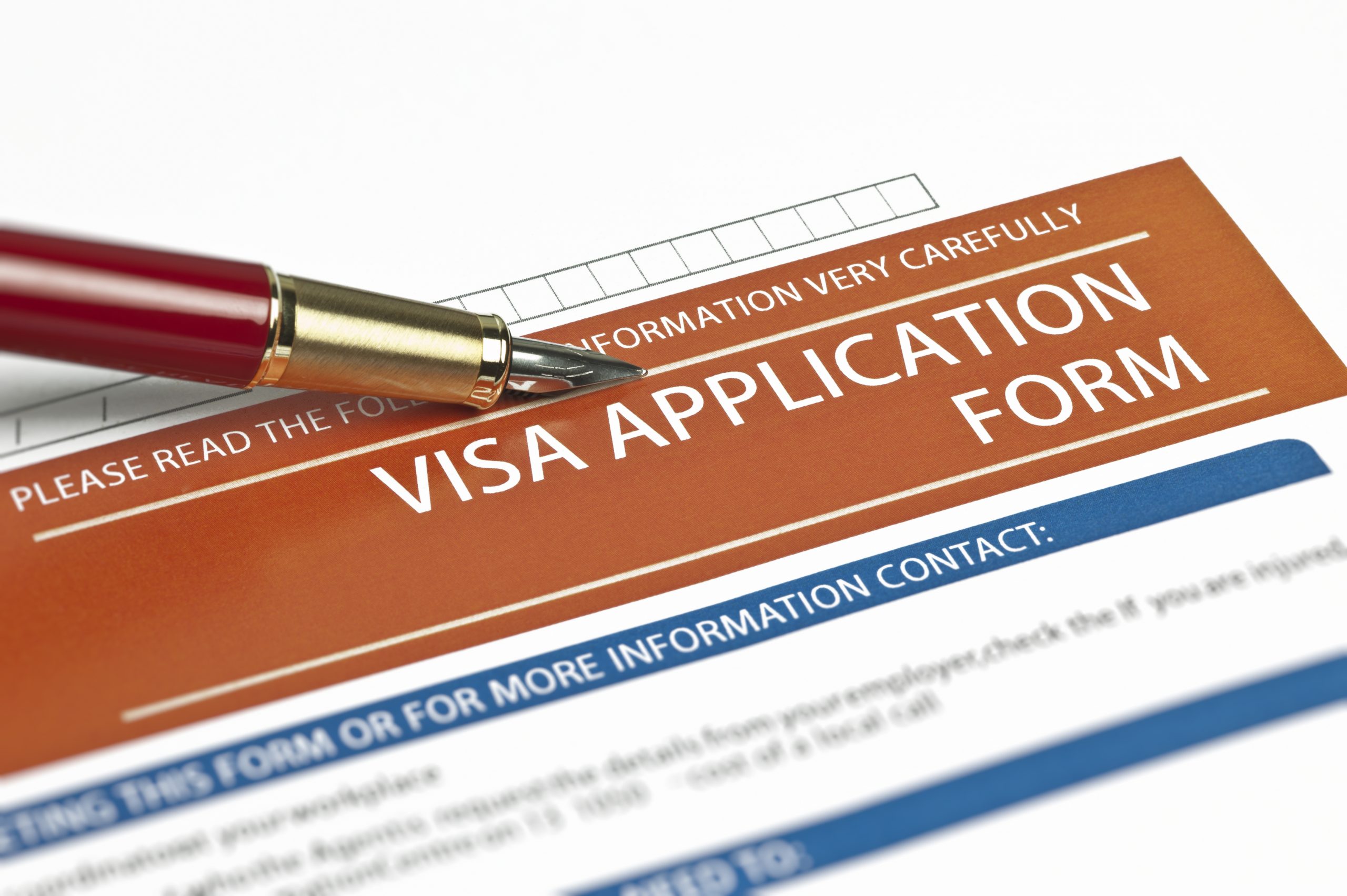 The top of a printed visa application can be seen. It says "Visa Application Form" at the top and below has contact information.