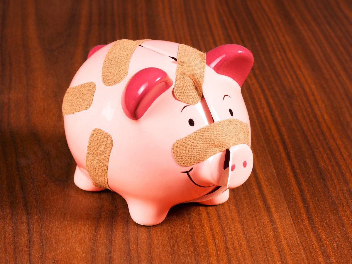Cracked piggy bank with band aid